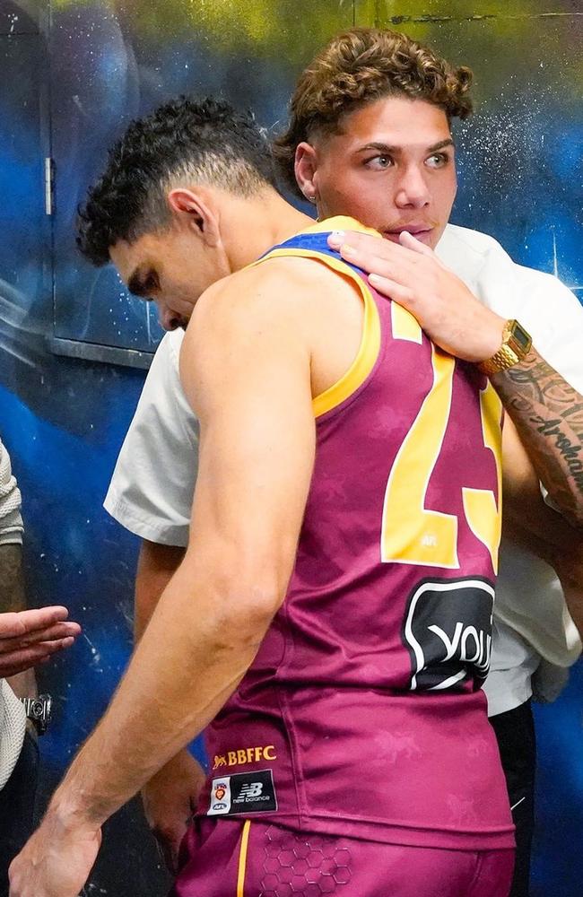 The Brisbane Lions’ Charlie Cameron with the Broncos’ Reece Walsh after the Lions defeated Port Adelaide at the Gabba