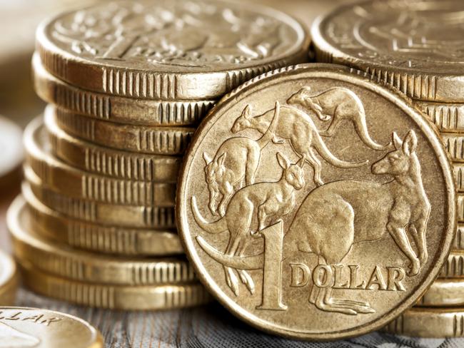 Stacks of Australian one dollar coins. Focus on front coin.