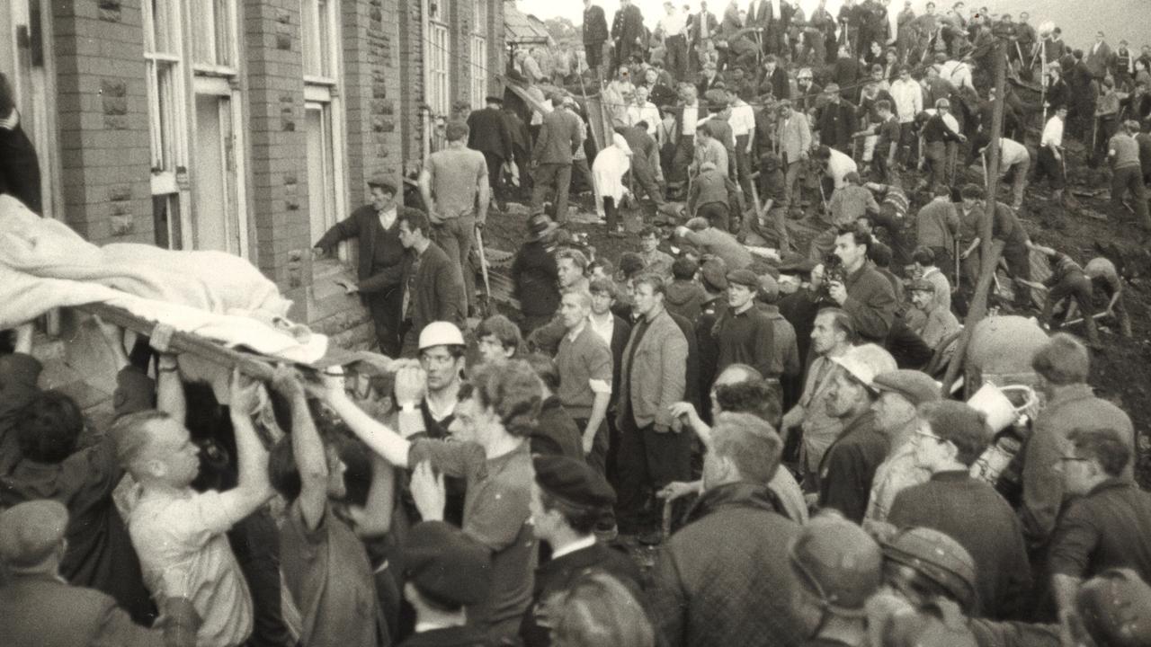 A body is taken from the schoolhouse in Aberfan after the disaster in October 1966.