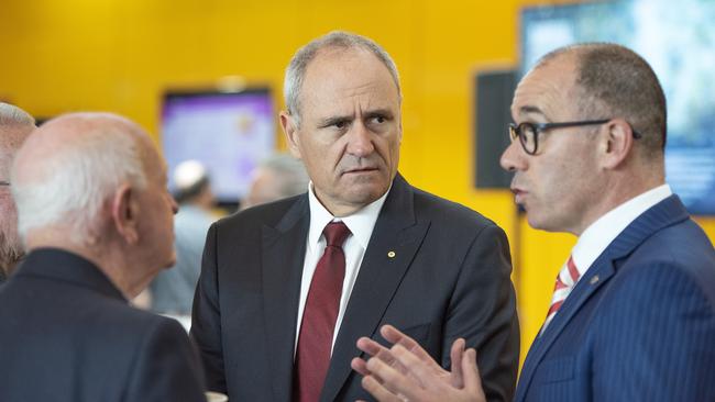 NAB chairman Ken Henry, centre, and NAB CEO Andrew Thorburn greet shareholders before the AGM in Melbourne. Pic: AAP