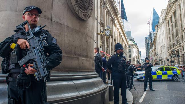 An armed police officer stands guard on the streets of London. Picture: Getty Images