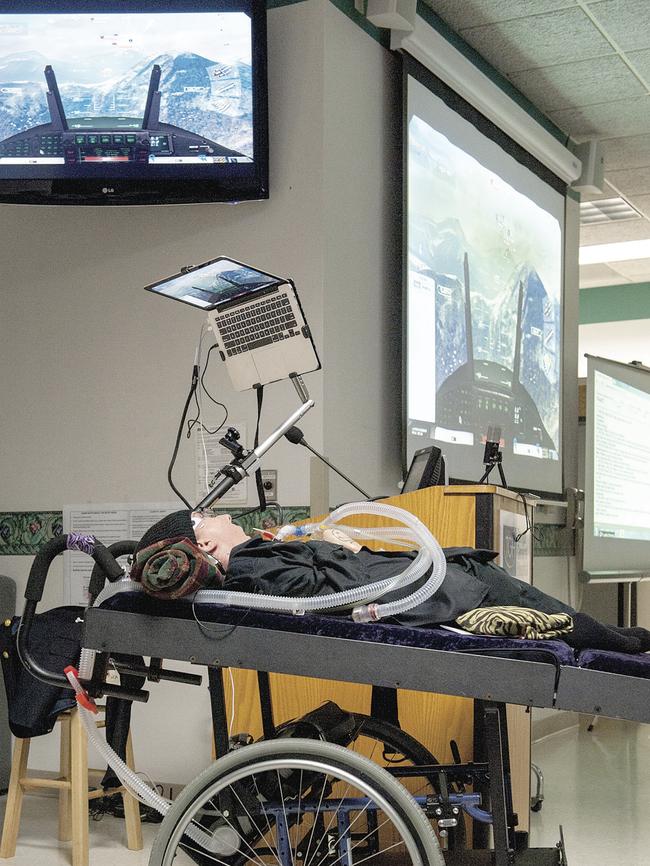 Michael Phillips is paralysed and cannot speak. But with the aid of technology, he can control an attack bomber computer game. Credit: Tampa General Hospital, Florida.