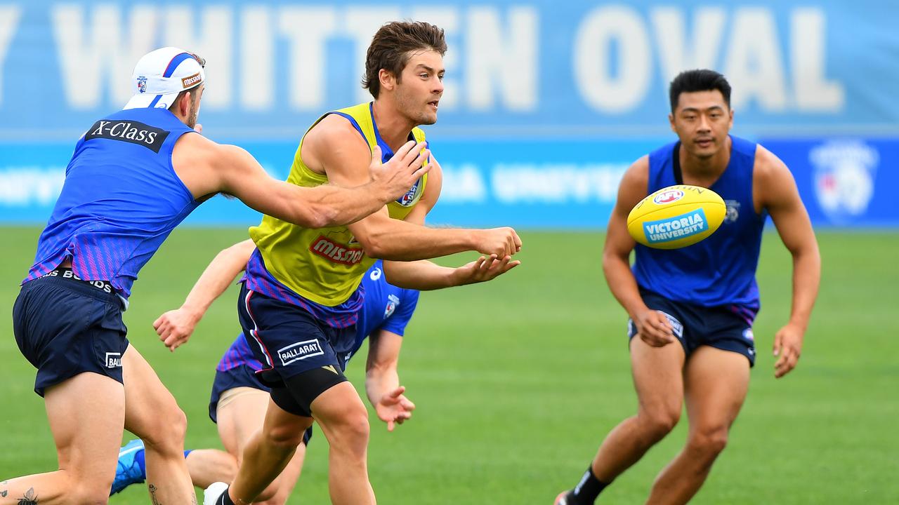 Josh Dunkley fires out a handpoass during Western Bulldogs training at Whitten Oval. Picture: James Ross/AAP