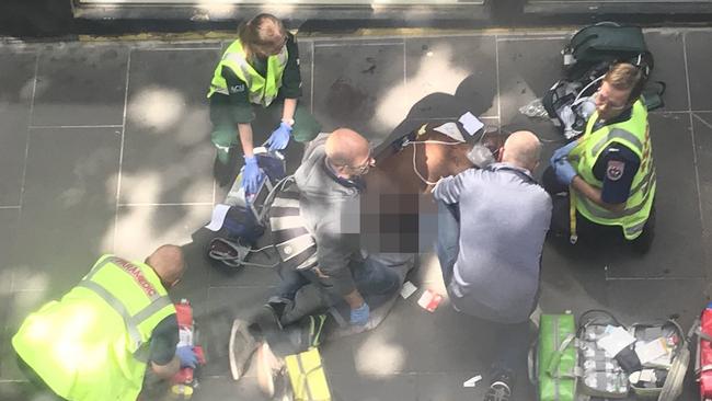 A man was arrested at the scene and has been taken to hospital under police guard in a critical condition. Picture: Josh Fagan