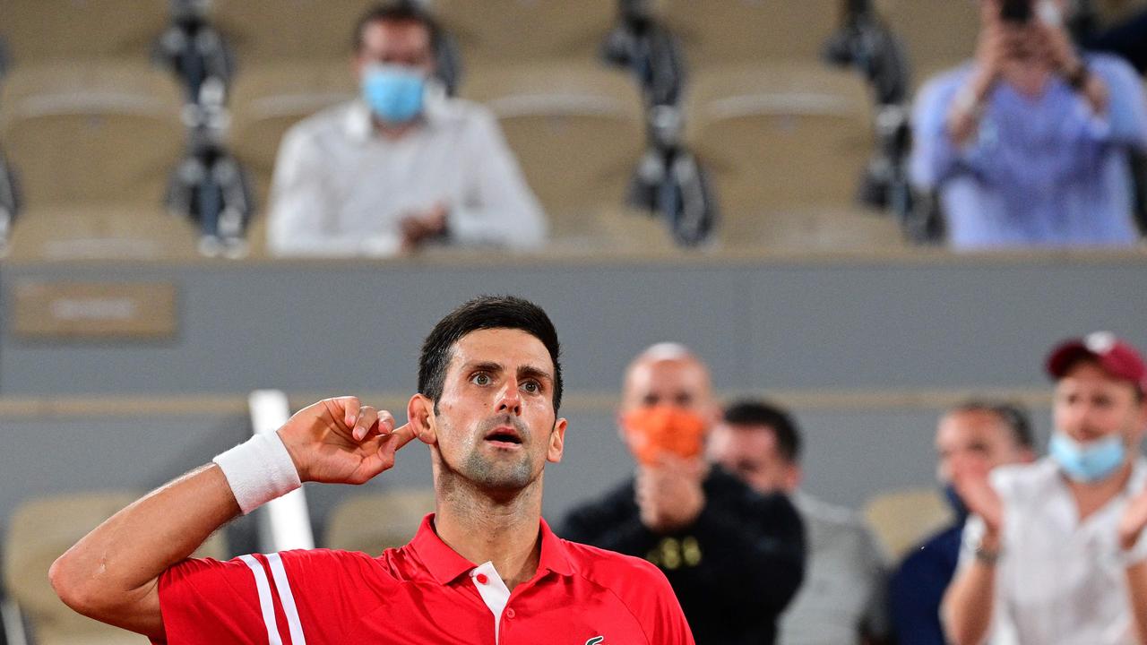TOPSHOT - Serbia's Novak Djokovic reacts during his men's singles semi-final tennis match against Spain's Rafael Nadal on Day 13 of The Roland Garros 2021 French Open tennis tournament in Paris on June 11, 2021. (Photo by MARTIN BUREAU / AFP)