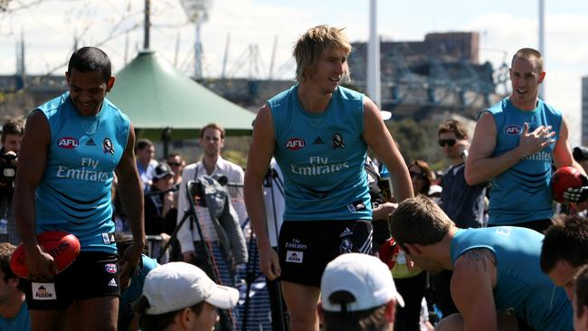 AFL- Collingwood Football Club trains for the last time before the Grand Final replay against St Kilda. Leon Davis, Dale Thomas and Nick Maxwell with the MCG in the background.