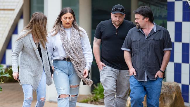 Friends and family of the victim gather outside Werribee Police Station, where police issued a call for public assistance. Picture: Sarah Matray