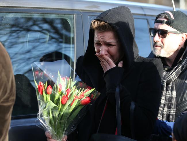 People arrive with bunches of flowers to lay in tribute outside Michael’s north London home. Picture: Daniel Leal-Olivas/AFP