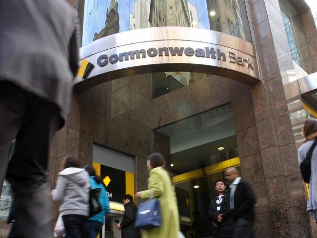 Pedestrians walk past a Commonwealth Bank of Australia Ltd, bank branch in Sydney, Australia, on Tuesday, Sept. 9, 2011. Photographer: Sergio Dionisio/Bloomberg