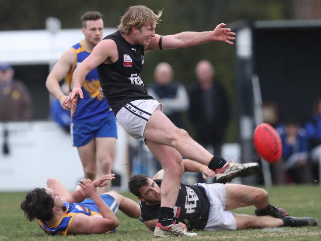 Luke Brown gets the ball on the boot. Picture: David Crosling