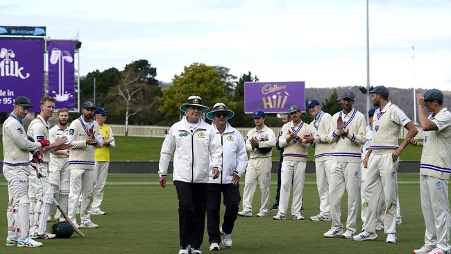 Umpires Simon Fry (left) and John Ward are applauded off the field after play on day 3 of the Marsh Sheffield Shield cricket match between the Tasmanian Tigers and the NSW Blues at Blundstone Arena in Hobart, Sunday, March 8, 2020. Picture: AAP Image/Dave Hunt