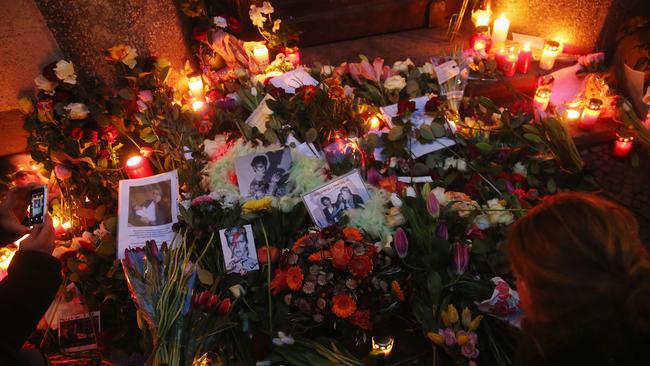 Fans lay flowers and candles at the doorstep at the building where British musician David Bowie once lived following the announcement of his death. Credit: Getty