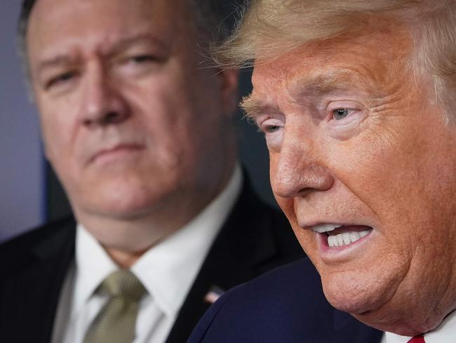 (FILES) In this file photo US Secretary of States Mike Pompeo listens as US President Donald Trump speaks during the daily briefing on the novel coronavirus, Covid-19, in the Brady Briefing Room at the White House on April 8, 2020, in Washington, DC. - Donald Trump in his final days in the White House has seen cabinet members quit, his vice president for the first time take a distance and some members of his party support impeachment. But he still has loyalty until the bitter end from Secretary of State Mike Pompeo. America's top diplomat has rammed forward 11th-hour hawkish policies and increasingly adopted the grievance-laden rhetoric of Trump's hard-right base, raising speculation that Pompeo has the White House in his own sights in 2024. (Photo by MANDEL NGAN / AFP)