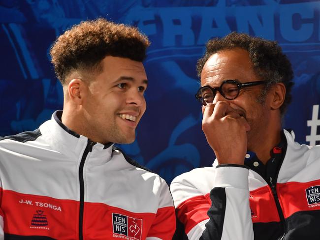 France's captain Yannick Noah (R) shares a joke with France's Jo-Wilfried Tsonga.