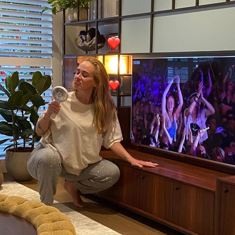 Adele watches her own Glasto set on TV in her PJs.