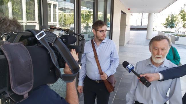 James Michael Waugh (with bag over shoulder) leaves the ACT Magistrates Court after pleading guilty to threatening to kill groups of two Canberra Christian churches. Picture: Craig Dunlop