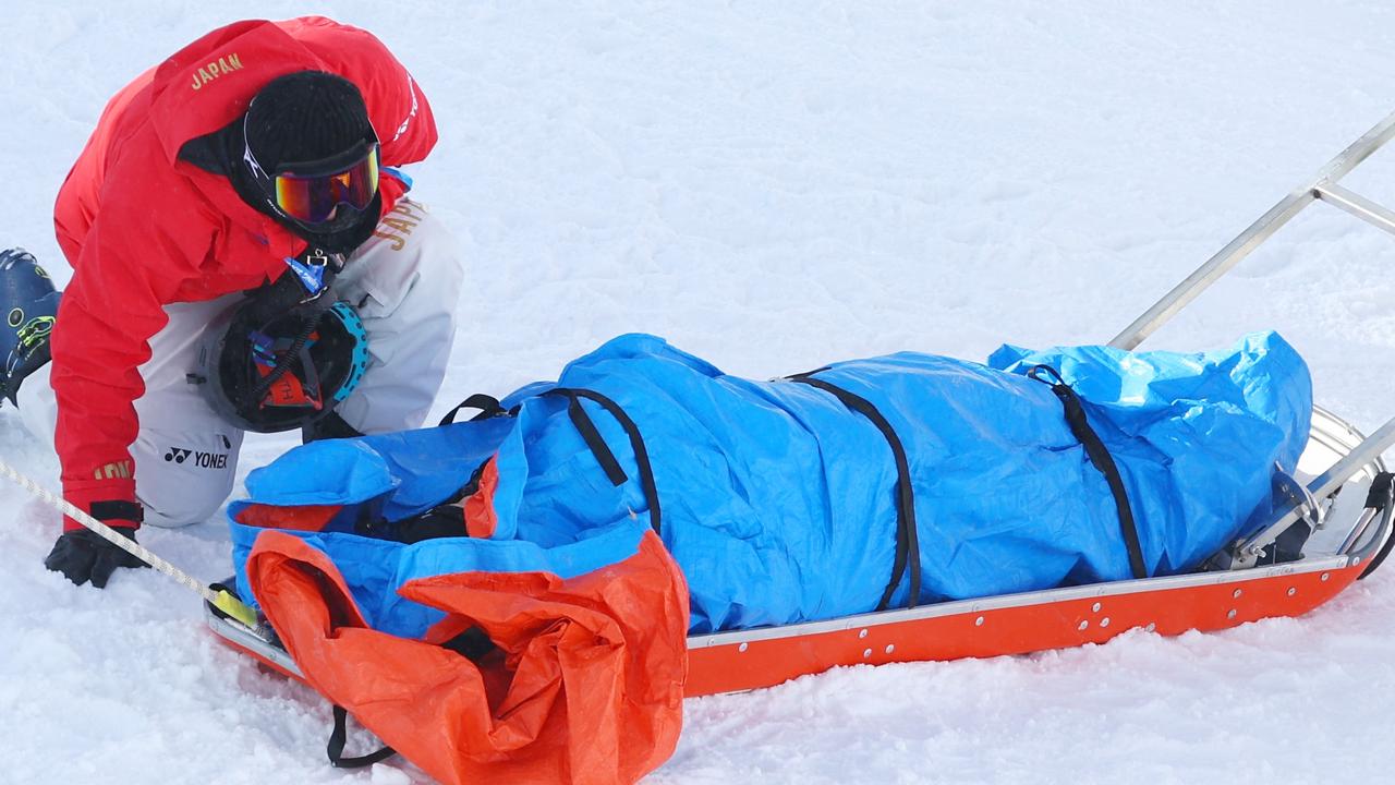 ZHANGJIAKOU, CHINA - FEBRUARY 03: Rina Yoshika of Team Japan receives medical attention after crashing during the Snowboard Slopestyle Training session ahead of the Beijing 2022 Winter Olympic Games at the Genting Snow Park on February 03, 2022 in Zhangjiakou, China. (Photo by Clive Rose/Getty Images)