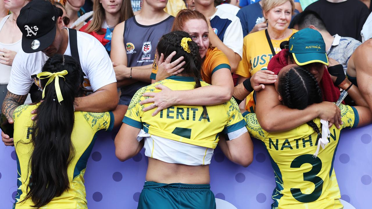 Heartbreak: Sariah Paki, Bienne Terita and Faith Nathan of Team Australia are comforted by members of the crowd following their defeat during their defeat in the bronze medal match against Team USA. Picture: Cameron Spencer/Getty Images