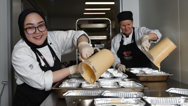 Pat Sukiam and Denise Grantham making banana bread in the FareShare kitchen. Picture: Josie Hayden