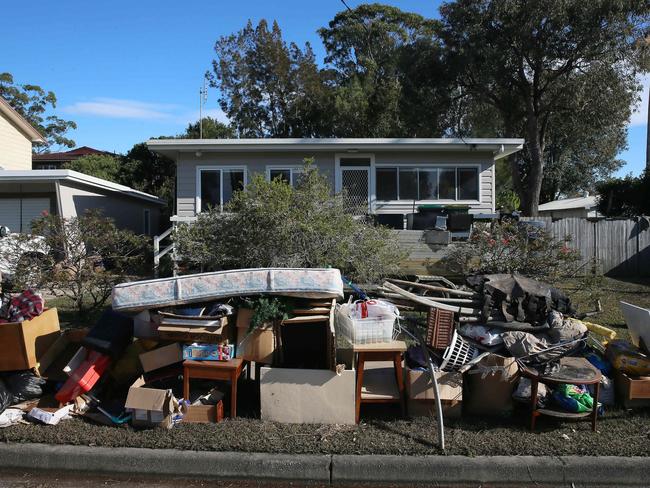 Aftermath of major flooding in and around Lakedge Ave as piles of destroyed furniture and household goods are collected. Picture: Sue Graham