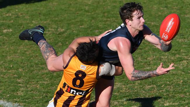 Cam O’Shea fires out a handball while being tackled against Box Hill. Picture: Andy Brownbill.