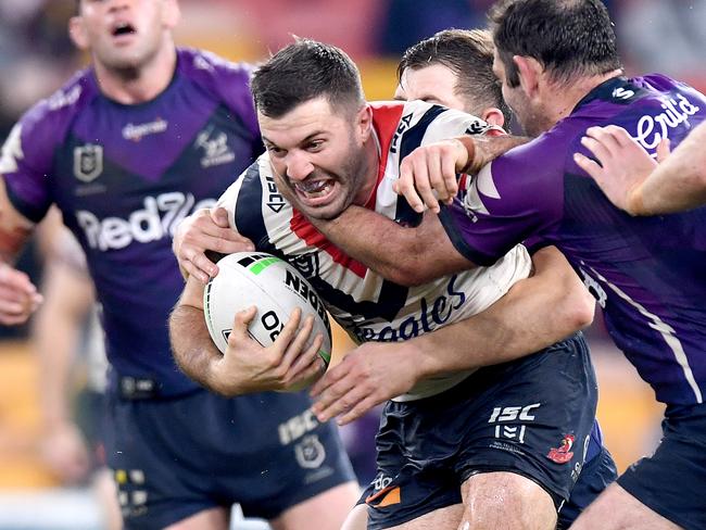 BRISBANE, AUSTRALIA - JULY 02: James Tedesco of the Roosters takes on the defence during the round eight NRL match between the Melbourne Storm and the Sydney Roosters at Suncorp Stadium on July 02, 2020 in Brisbane, Australia. (Photo by Bradley Kanaris/Getty Images)