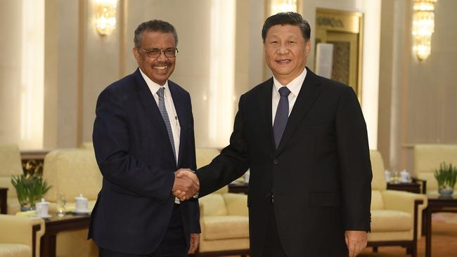 Tedros Adhanom Ghebreyesus, director general of the World Health Organisation, left, shakes hands with Chinese President Xi Jinping.