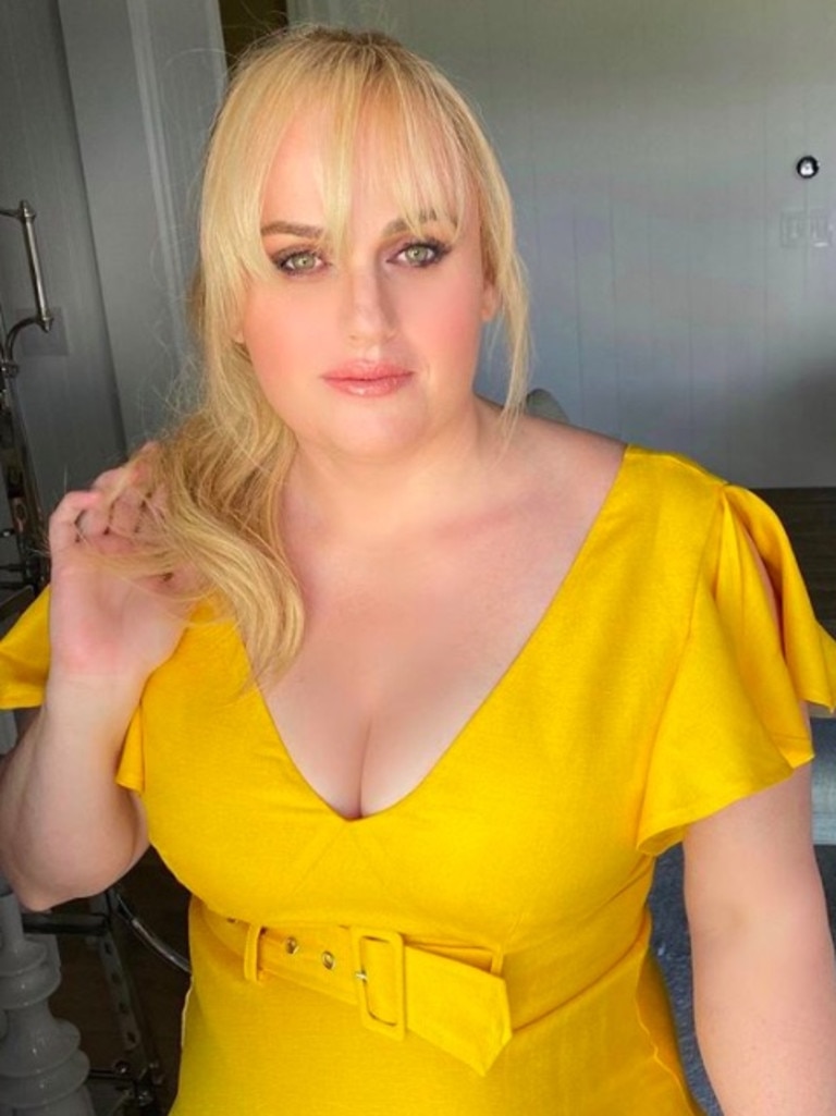 Wilson dolled up in a belted yellow dress.