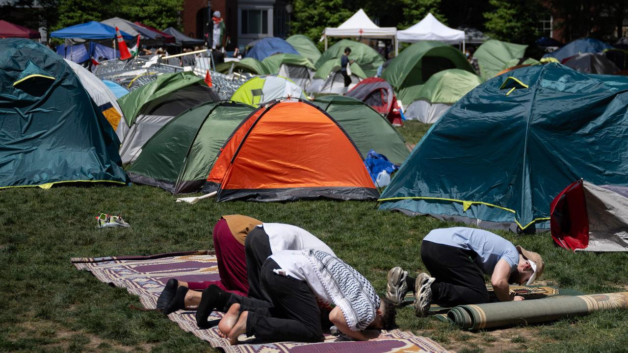 Pro-Palestinian students and activists pray at the encampment on the campus of George Washington University. (Photo by Drew ANGERER / AFP)