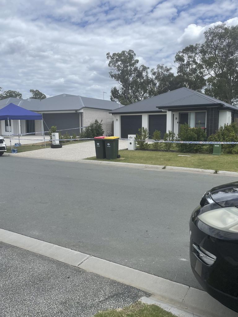 Police tape remained at the Logan Reserve house on Sunday, as the investigation into the woman's death continued. Picture: Chloe Grimshaw