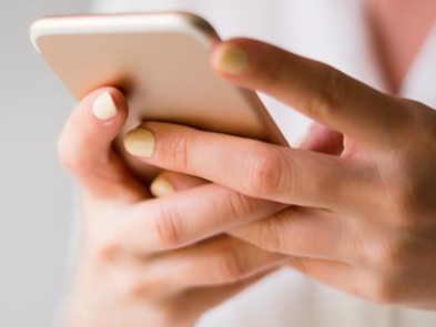 Close up of a woman using her smartphone indoors. generic. istock