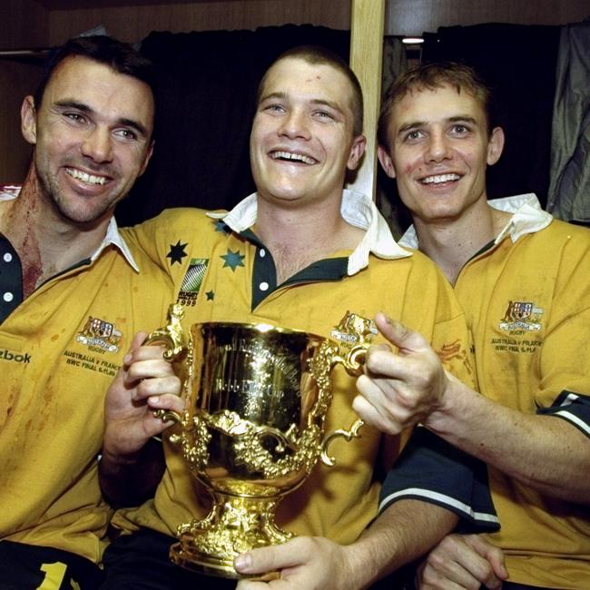 Joe Roff, Ben Tune and Stephen Larkham of Australia celebrate victory over France in the Rugby World Cup Final in 1999.