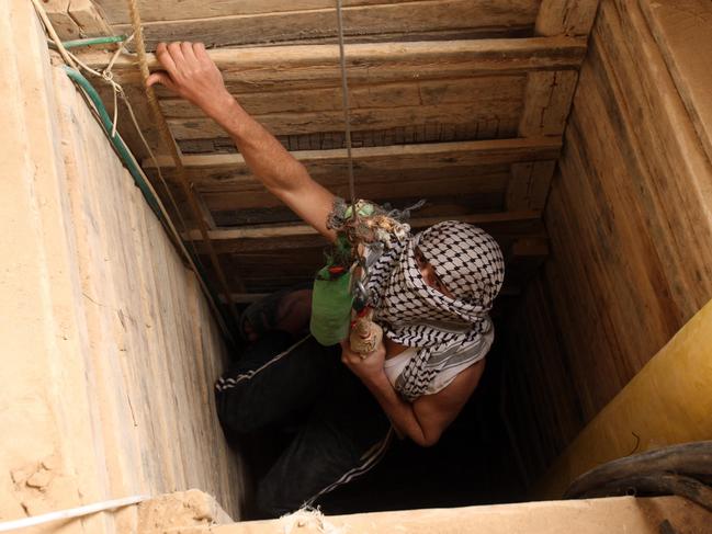 A Palestinian enters a tunnel in the southern Gaza Strip that runs under the Egyptian border and into Gaza at Rafah, in January 2009.