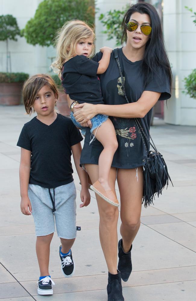 Kourtney out with Mason and Penelope wearing matching Yeezy T-shirts.