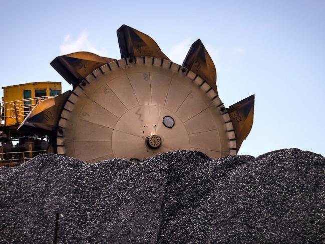 An excavator on a pile of coal at the Port of Newcastle. Photographer: David Gray/Bloomberg