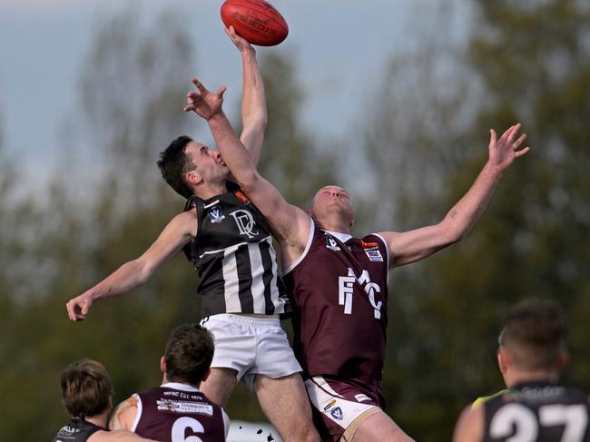 Darley’s Will Johnson jumps over Brett McIntyre of Melton. Picture: Andy Brownbill