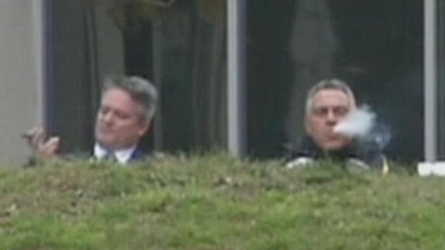 Cigar days ... Finance Minister Mathias Cormann and Treasurer Joe Hockey were pictured enjoying cigars shortly after the budget was announced, but were they celebrating too early? Picture: Twitter / Simon Cullen