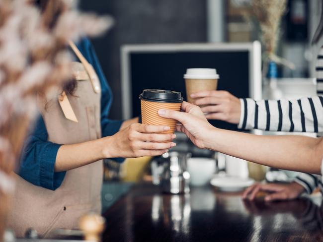 General iStock pics for Best Cafe poll.  Barista served take away hot coffee cup to customer at counter bar in cafe restaurant,coffee shop business owner concept,Service mind waitress. Picture: iStock