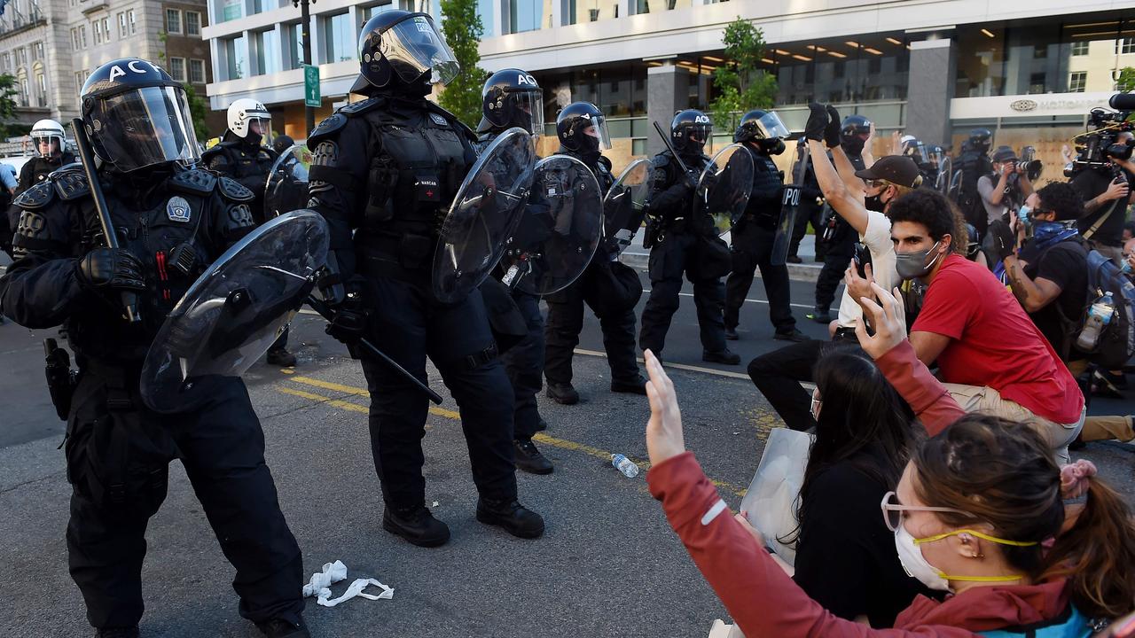 Protesters kneel and hold up their hands near the White House in Washington, DC. Picture: Olivier Douliery/AFP