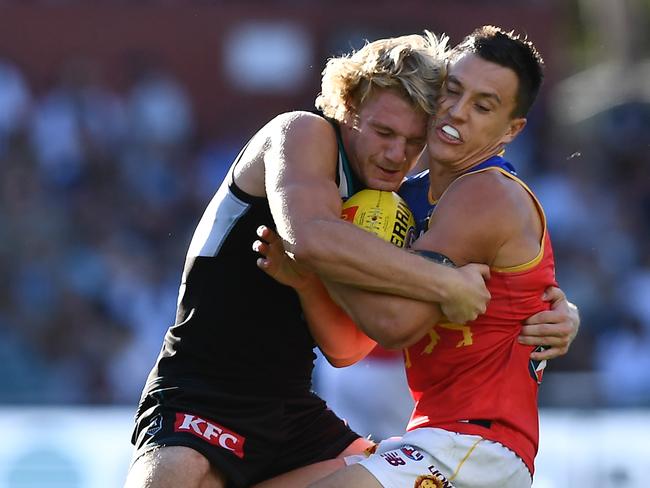 ADELAIDE, AUSTRALIA - MARCH 18: Hugh McCluggage of the Lions tackled by Jason Horne-Francis of Port Adelaide during the round one AFL match between Port Adelaide Power and Brisbane Lions at Adelaide Oval, on March 18, 2023, in Adelaide, Australia. (Photo by Mark Brake/Getty Images)