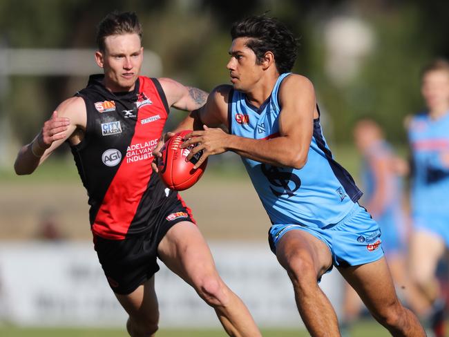 2/6/2018 SANFL: Shane McAdam of the double blues evades Errin Wasley Black of the Bloods. West Adelaide v Sturt at Richmond Oval. Picture MATT TURNER.