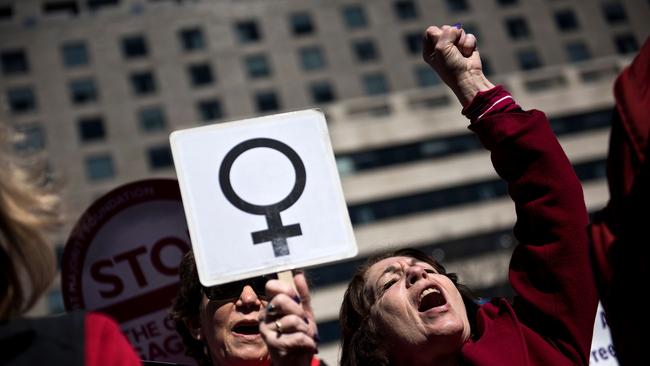 Activists protest the Trump administration and rally for women's rights during a march to honor International Woman's Day in Washington, DC.