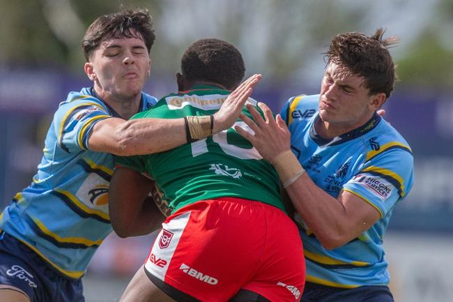 James Grey (Redcliffe SHS) and Hayden Polson make a tackle for Norths. They will go up against each other in the school season.
