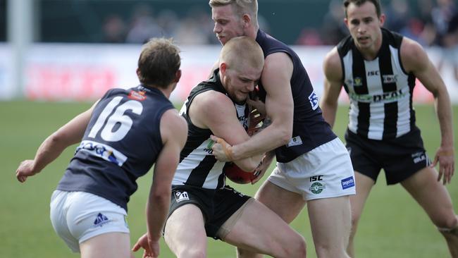 Mitch Rainbird is tackled by Launceston's Jack Donnellan (right) Picture: LUKE BOWDEN