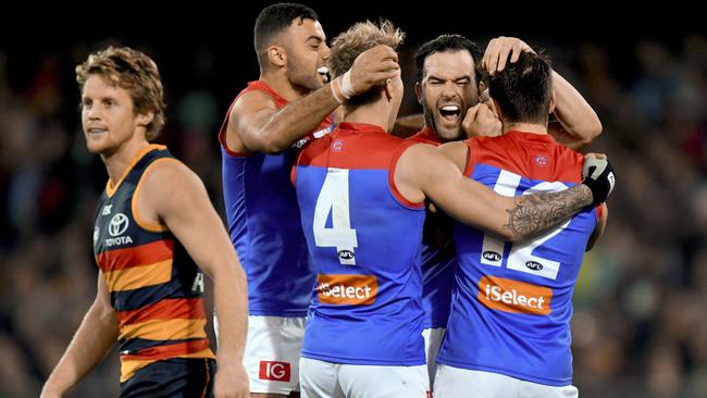 Melbourne players celebrate a Jordan Lewis goal.