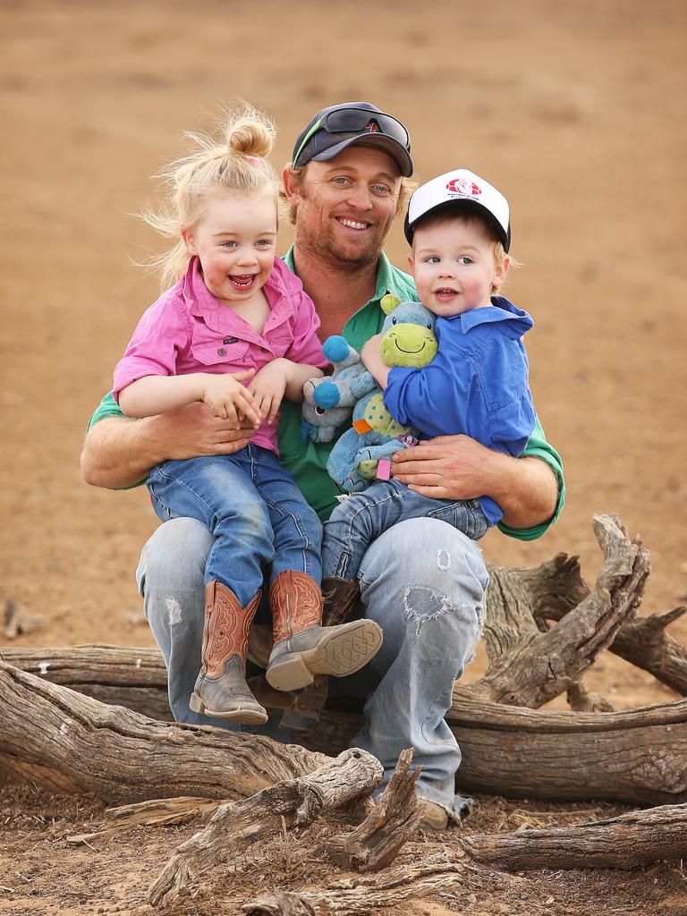 Peter Holcombe, 32, Eve Holcombe, 3, Finn Holcombe, 2 on their dry land near Walgett. Picture: Sam Ruttyn