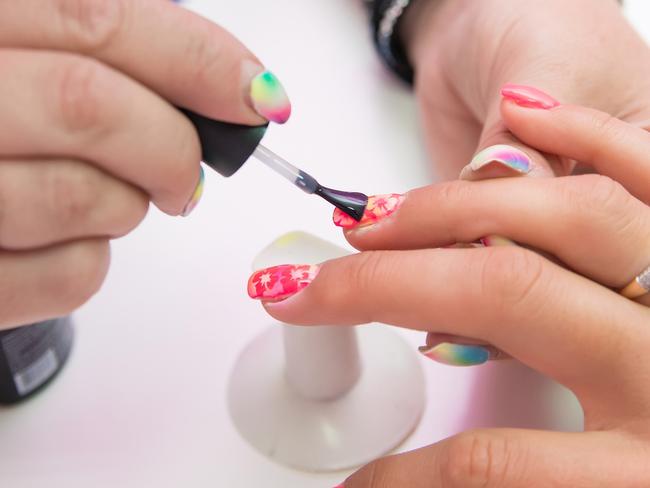 Generic pic of woman in salon receiving manicure by nail technician. Pic: iStock