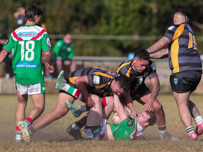 Mitchell Reeve put on his back by the ferocious Tigers defence. Picture: Adam Wrightson Photography