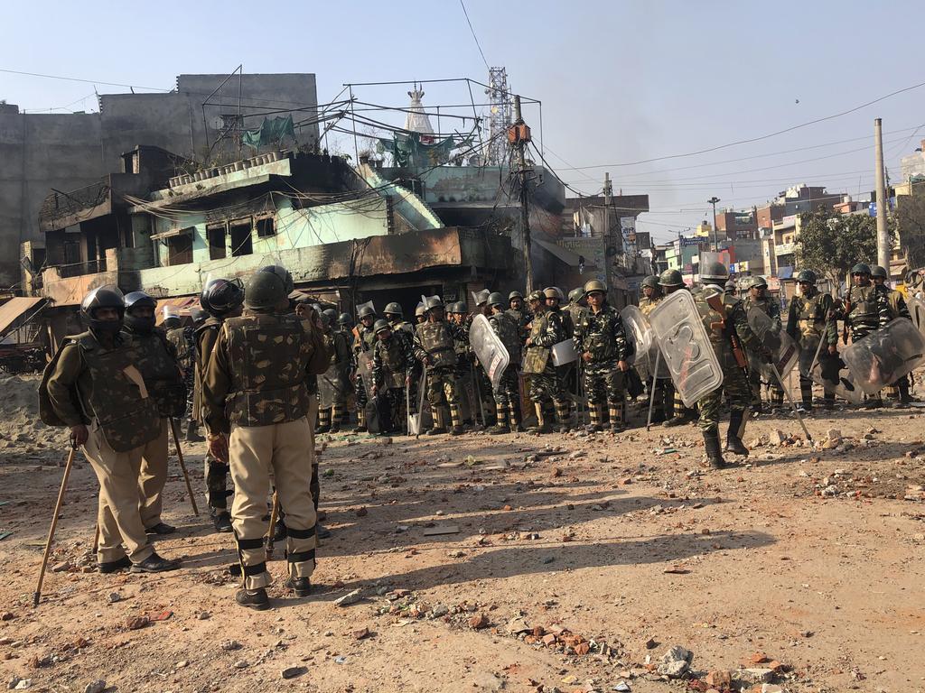 Indian security officers guard a street in a locality experiencing violence between two groups in Bhajanpura area of New Delhi. Picture: AP