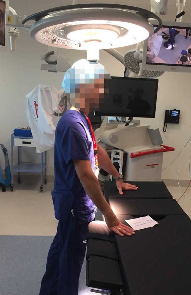 A surgeon and a low-hanging light in a new Royal Adelaide Hospital operating theatre.